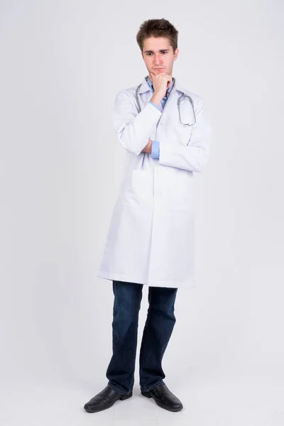 Full body shot of serious young man doctor thinking — Stock Photo, Image