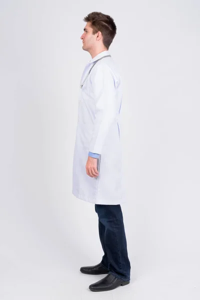 Full body shot profile view of young handsome man doctor — Stock Photo, Image