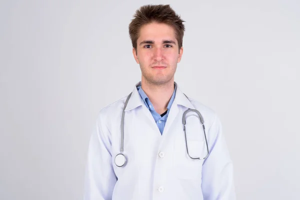 Young handsome man doctor against white background — Stock Photo, Image