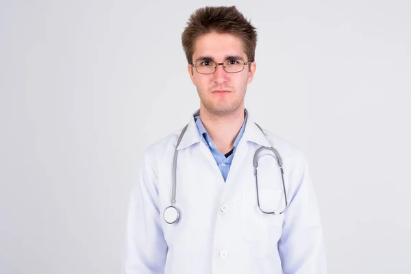 Young handsome man doctor with eyeglasses against white background — Stock Photo, Image