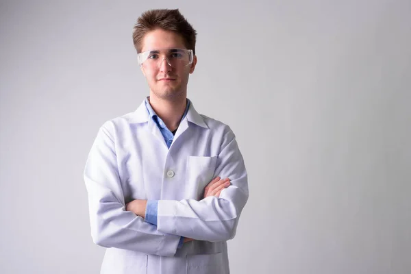 Young handsome man doctor with protective glasses — Stock Photo, Image