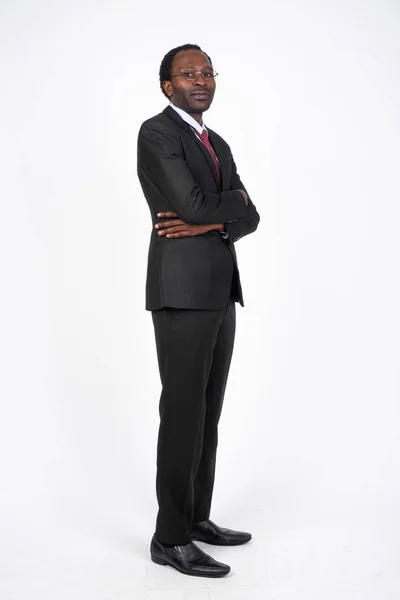 Vista del perfil de plano de cuerpo completo del empresario africano mirando la cámara —  Fotos de Stock