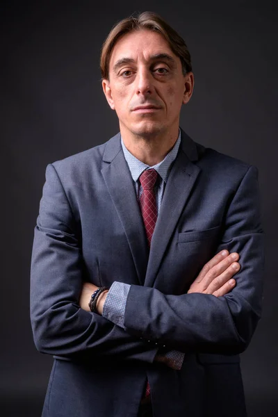 灰色の背景を持つ成熟したハンサムなイタリアのビジネスマン — ストック写真