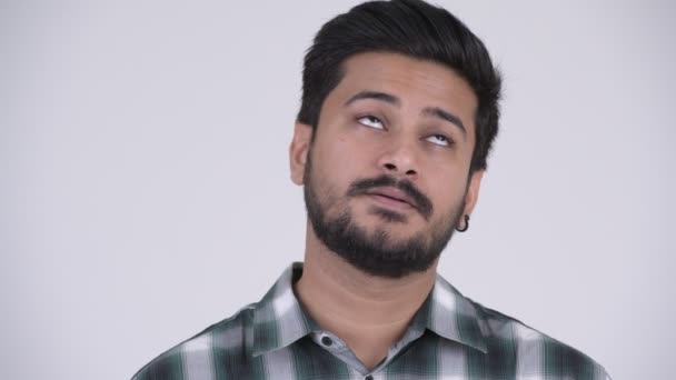 Portrait of young bearded Indian man looking tired and bored — Stock Video