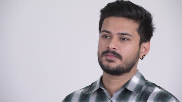Young handsome bearded Indian man thinking while talking — Stock Video