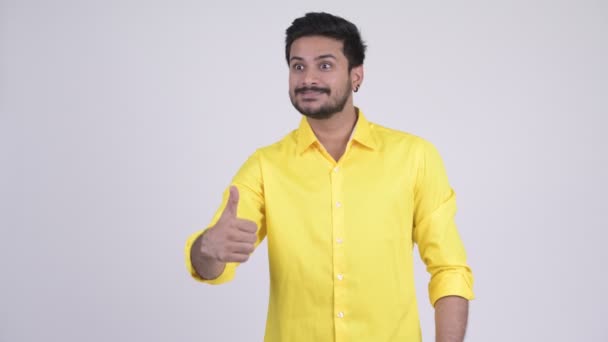 Young happy bearded Indian businessman giving thumbs up — Stock Video