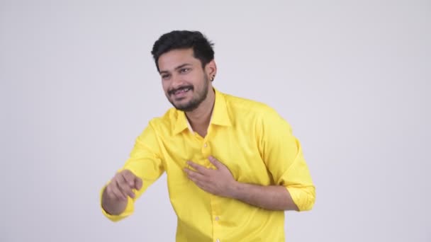 Young happy bearded Indian businessman laughing while pointing finger — Stock Video