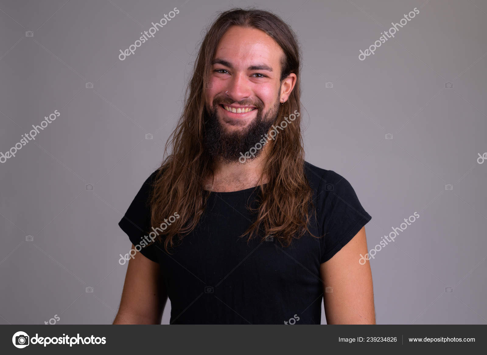 Young Happy Bearded Man With Long Hair Smiling Stock Photo