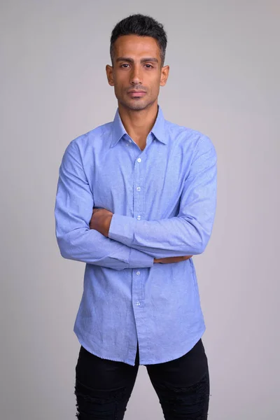 Portrait of young handsome Persian businessman with arms crossed — Stock Photo, Image