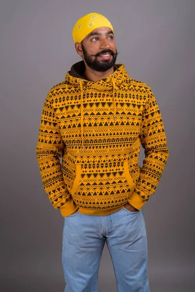 Portrait of young handsome Indian man wearing hoodie — Stock Photo, Image