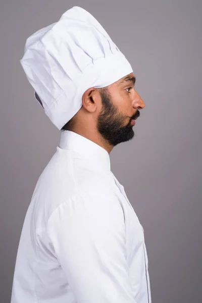 Вид профілю молодий індійський чоловік шеф-кухаря на сірому тлі — стокове фото