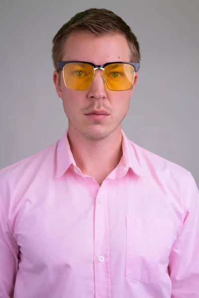 Gesicht eines coolen jungen gutaussehenden Geschäftsmannes mit gelber Sonnenbrille — Stockfoto