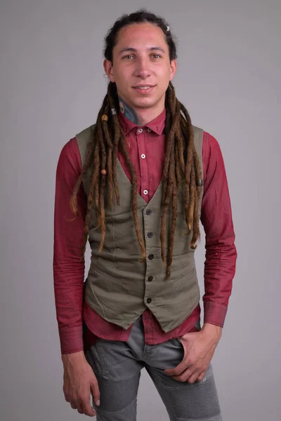 Portrait of young happy businessman with dreadlocks smiling — Stock Photo, Image