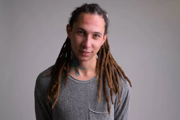 Portrait of happy young handsome man with dreadlocks smiling — Stock Photo, Image
