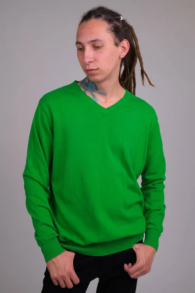 Portrait of serious young handsome man with dreadlocks thinking — Stock Photo, Image