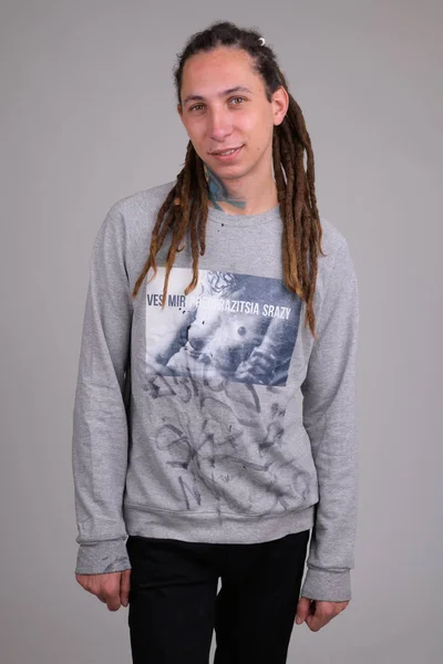 Portrait of happy young handsome man with dreadlocks smiling — Stock Photo, Image