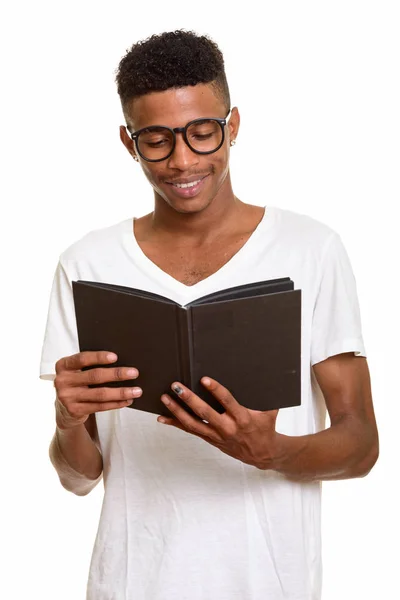 Young happy African man reading book isolated against white background — Stock Photo, Image