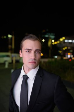Açık havada geceleri düşünme genç işadamı portresi