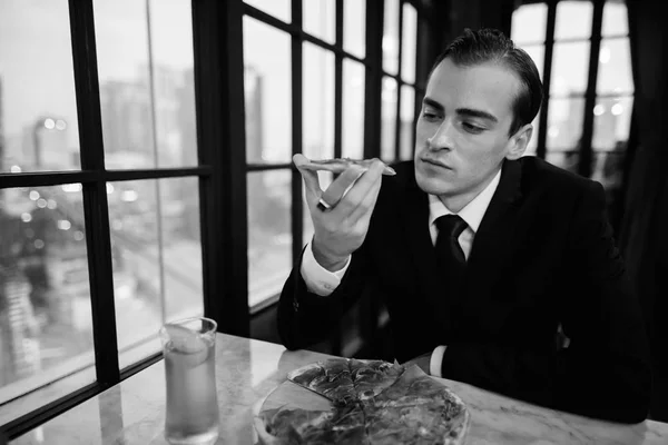 Black and white image of businessman sitting in restaurant — Stock Photo, Image