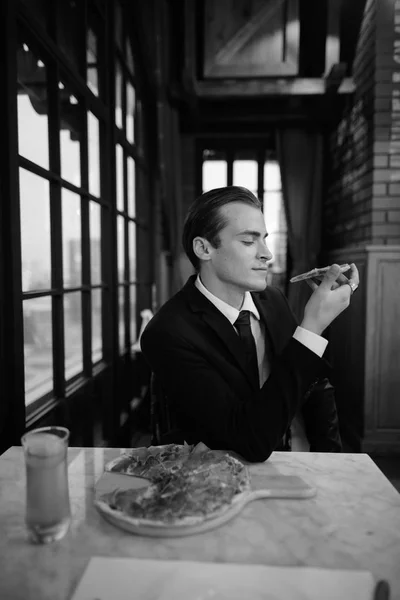 Black and white image of businessman sitting in restaurant — Stock Photo, Image