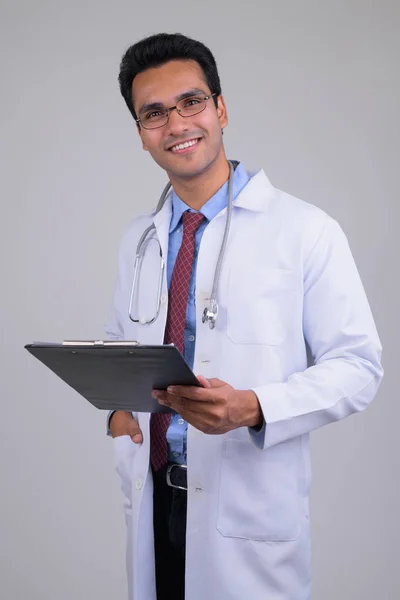 Feliz jovem bonito indiano homem médico segurando prancheta — Fotografia de Stock