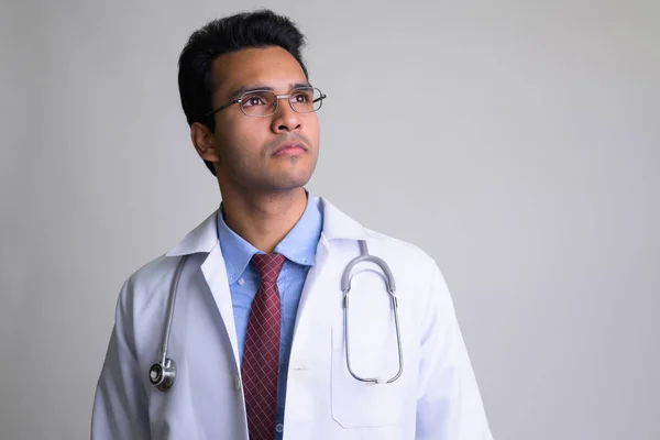Portrait of young Indian man doctor thinking — Stock Photo, Image