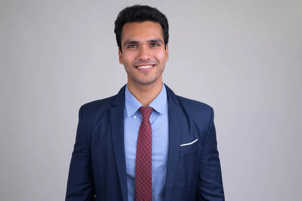 Portrait of happy young handsome Indian businessman smiling — Stock Photo, Image