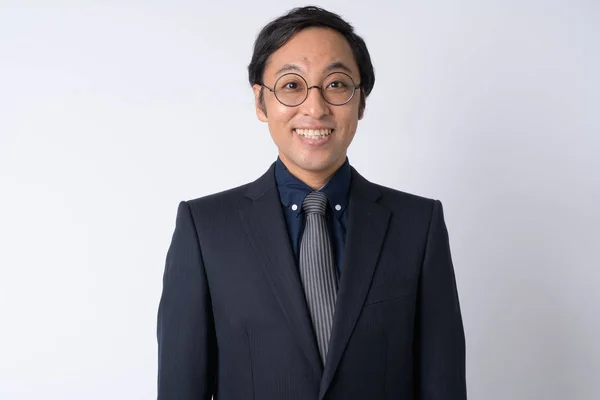 Portrait of happy Japanese businessman in suit smiling — Stock Photo, Image