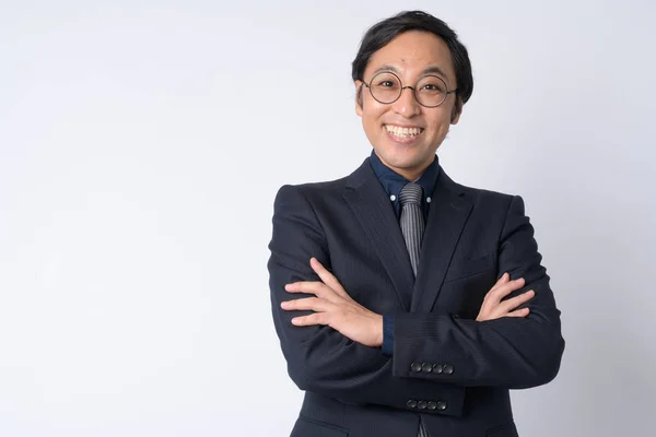 Portrait of happy Japanese businessman in suit with arms crossed — Stock Photo, Image
