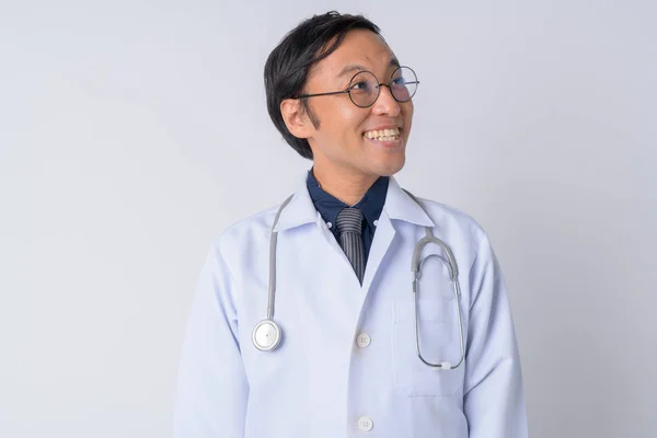 Portrait of happy Japanese man doctor thinking — Stock Photo, Image