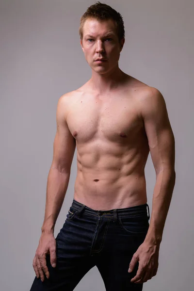 Studio shot of young handsome muscular shirtless man — Stock Photo, Image