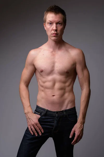 Studio shot of young handsome muscular shirtless man — Stock Photo, Image