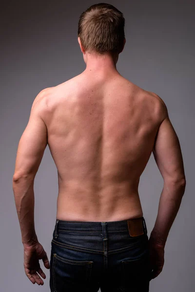 Rear view of young muscular shirtless man — Stock Photo, Image