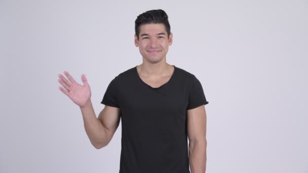 Feliz joven guapo multi-étnico hombre saludando mano — Vídeo de stock
