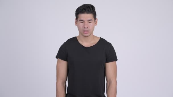 Boos multi-etnische jongeman met gekruiste armen — Stockvideo