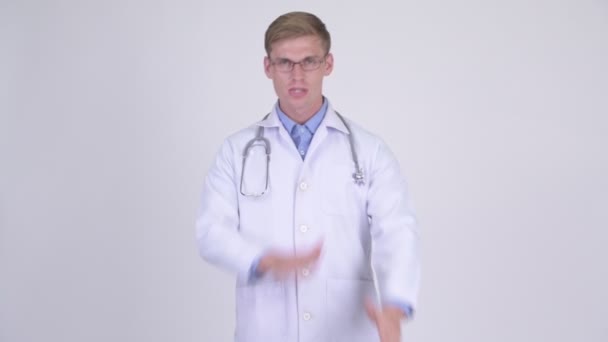 Young handsome man doctor showing stop gesture using arms — Stock Video