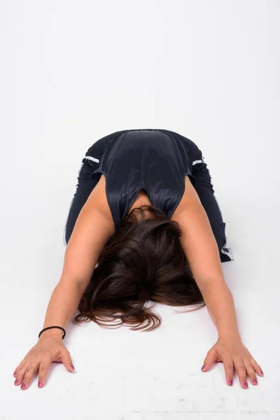 Full body shot of young Asian woman doing Child yoga pose — Stock Photo, Image