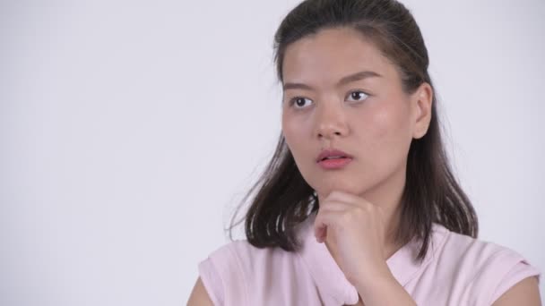 Face of happy young Asian businesswoman thinking and looking up — Stock Video