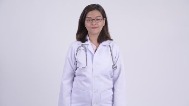 Happy young beautiful Asian woman doctor giving handshake — Stock Video