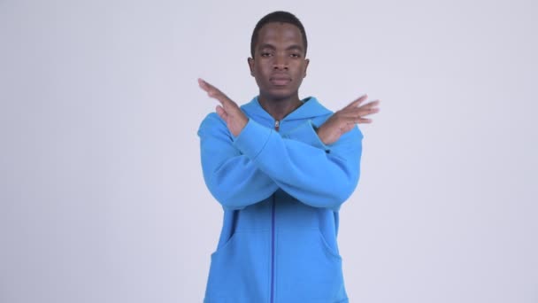 Young serious African man with stop gesture using arms — Stock Video