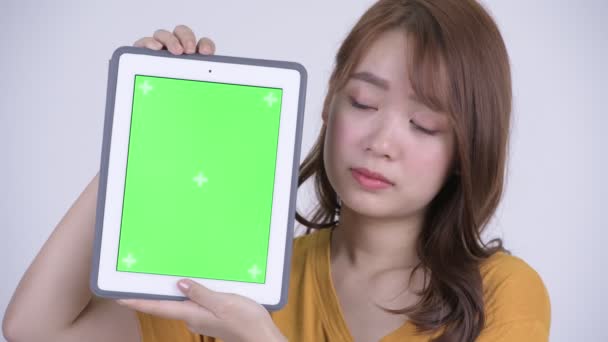 面对快乐的年轻美丽的亚洲女人展示数字平板电脑 — 图库视频影像