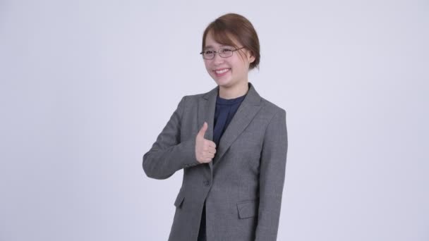 Young happy Asian businesswoman giving thumbs up — Stock Video