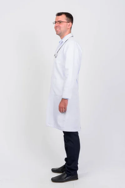 Full body shot profile view of happy man doctor smiling — Stock Photo, Image