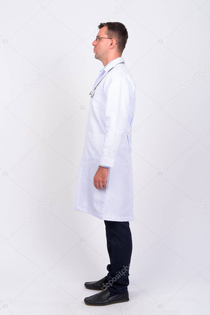 Full body shot profile view of man doctor with eyeglasses