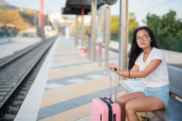 Young Beautiful Asian Tourist Woman Sitting While Waiting At The Train Station