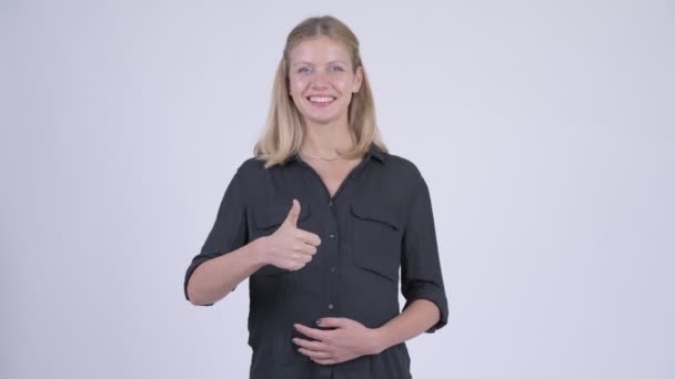 親指をあきらめて若い幸せ妊娠実業家 — ストック動画