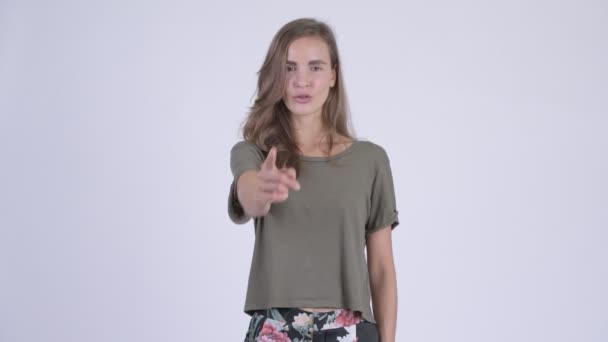 Happy young beautiful woman pointing at camera — Stock Video