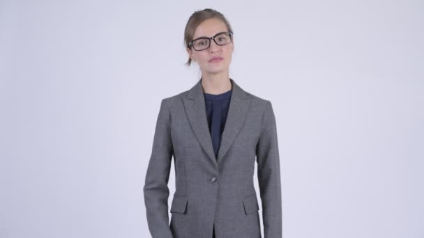 Young beautiful businesswoman wearing eyeglasses with arms crossed — Stock Video