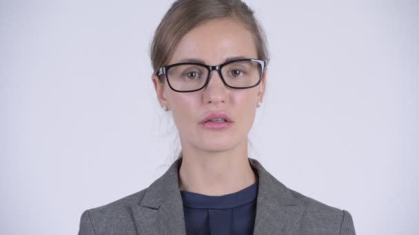Face of young beautiful businesswoman covering mouth as three wise monkeys concept — Stock Video