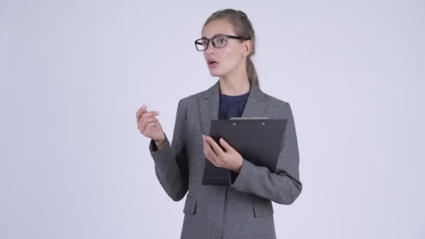 Молода красива бізнес-леді говорить, тримаючи буфер обміну — стокове відео